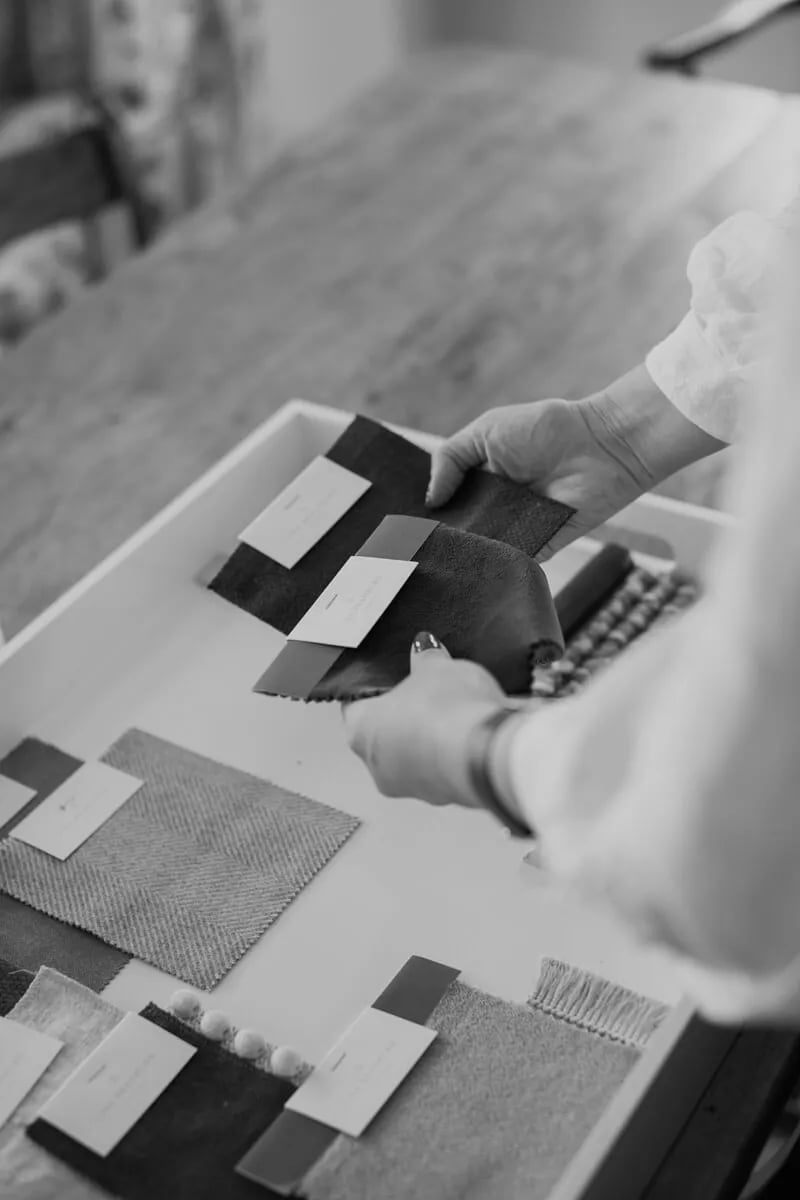 Material samples and a small architectural model arranged on a work surface