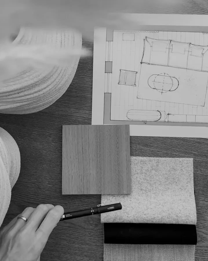 Interior design plans and material samples arranged on a desk